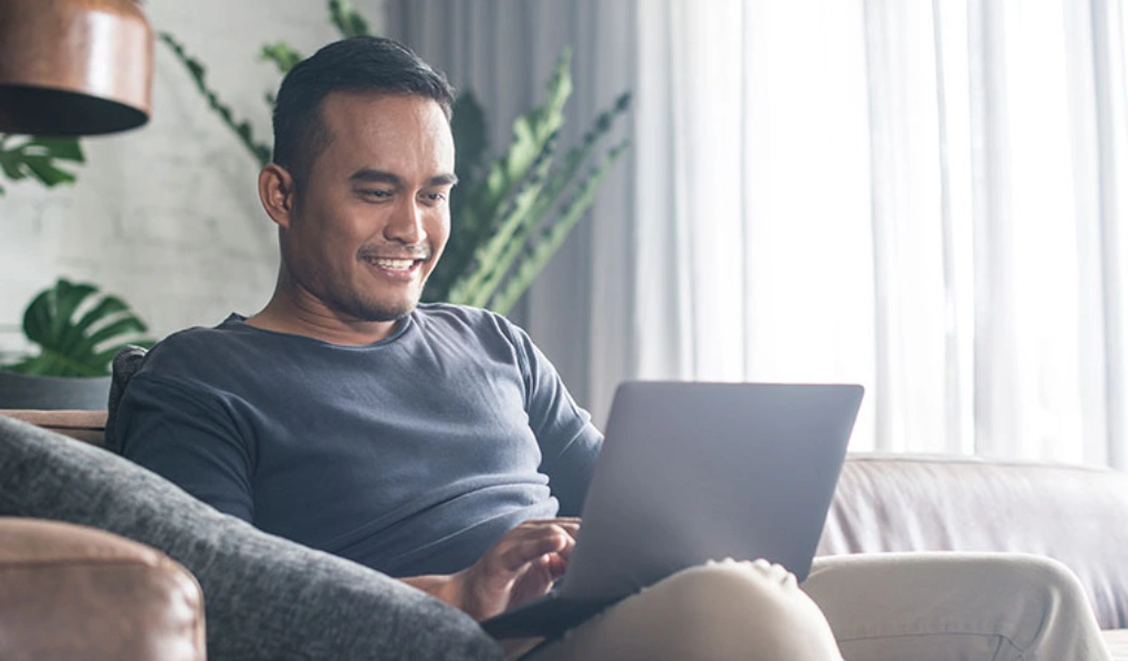 Man working on laptop in his home