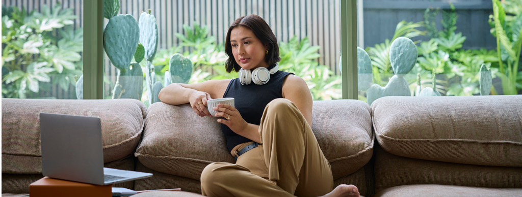 Young female marketing student studying on the couch.
