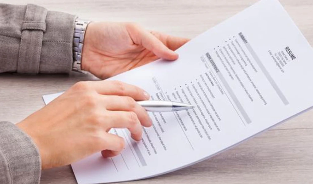 Hands signing a contract