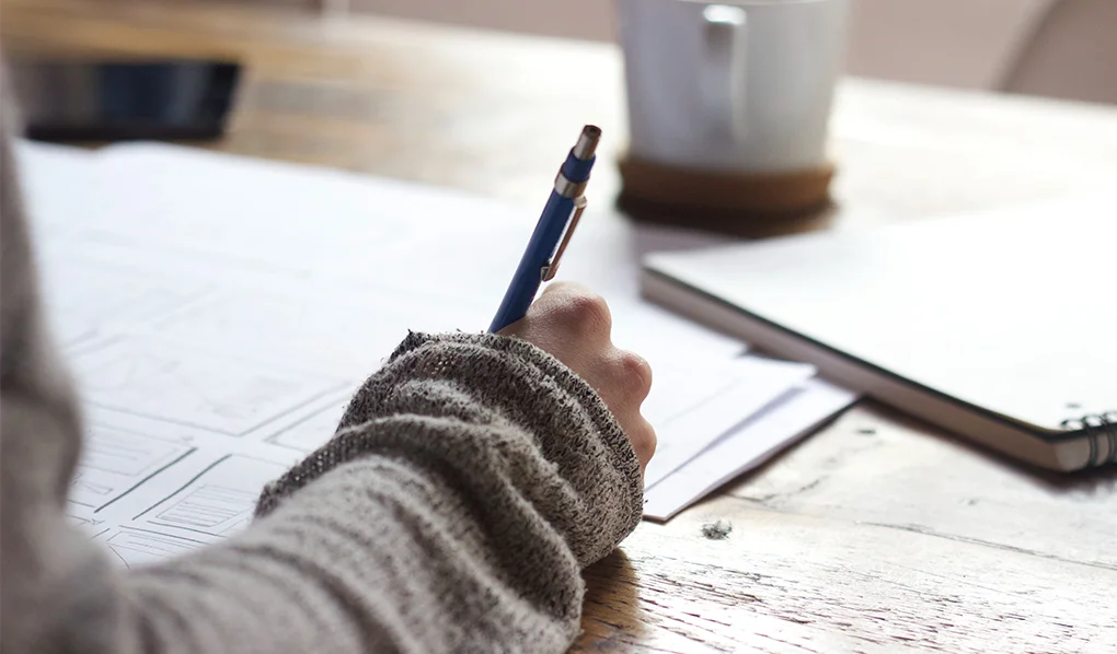 Student writing notes