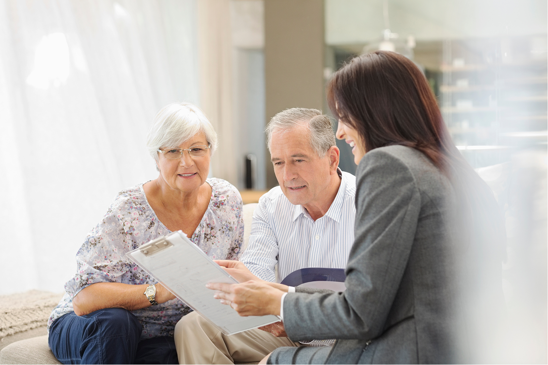 Young financial planner woman consulting an elderly couples finance needs.