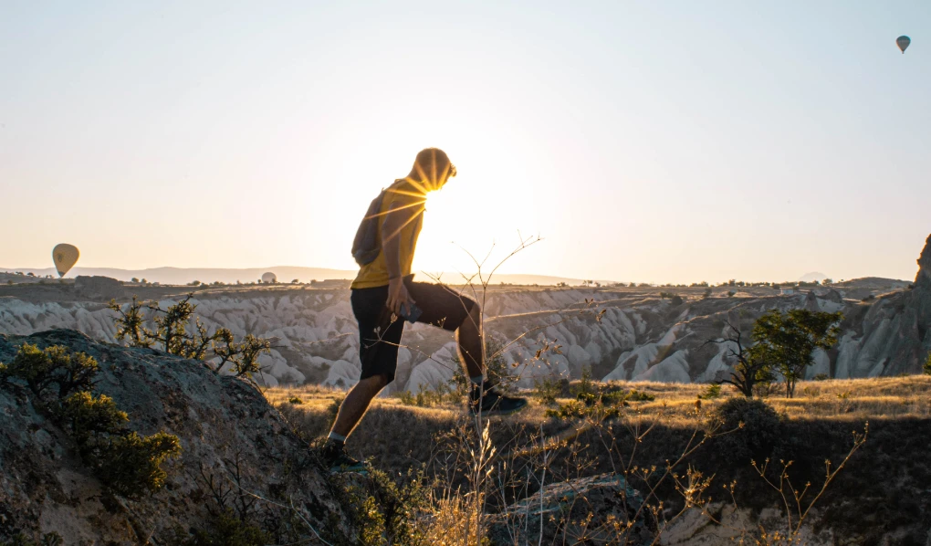 Young man on hike at sunset