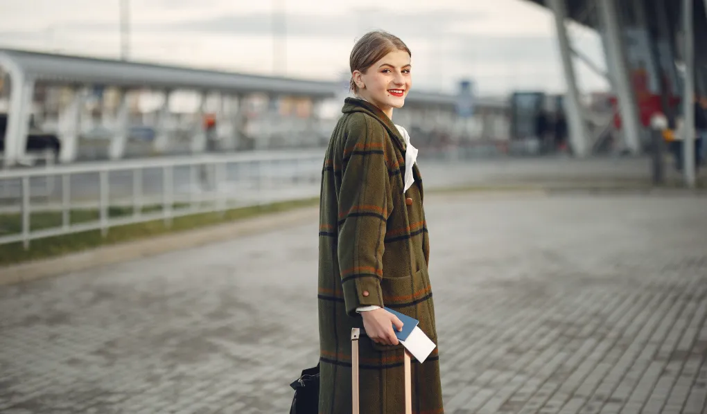 Young student ready with luggage and passport