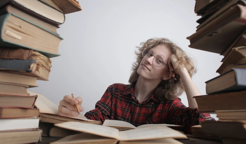 Student surrounded by books