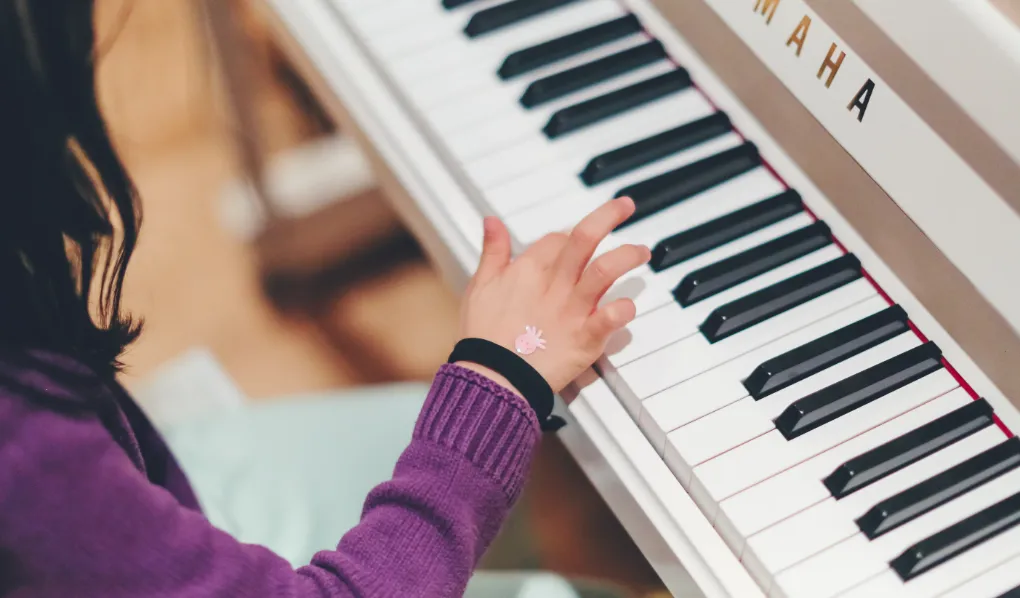 Young music student playing piano