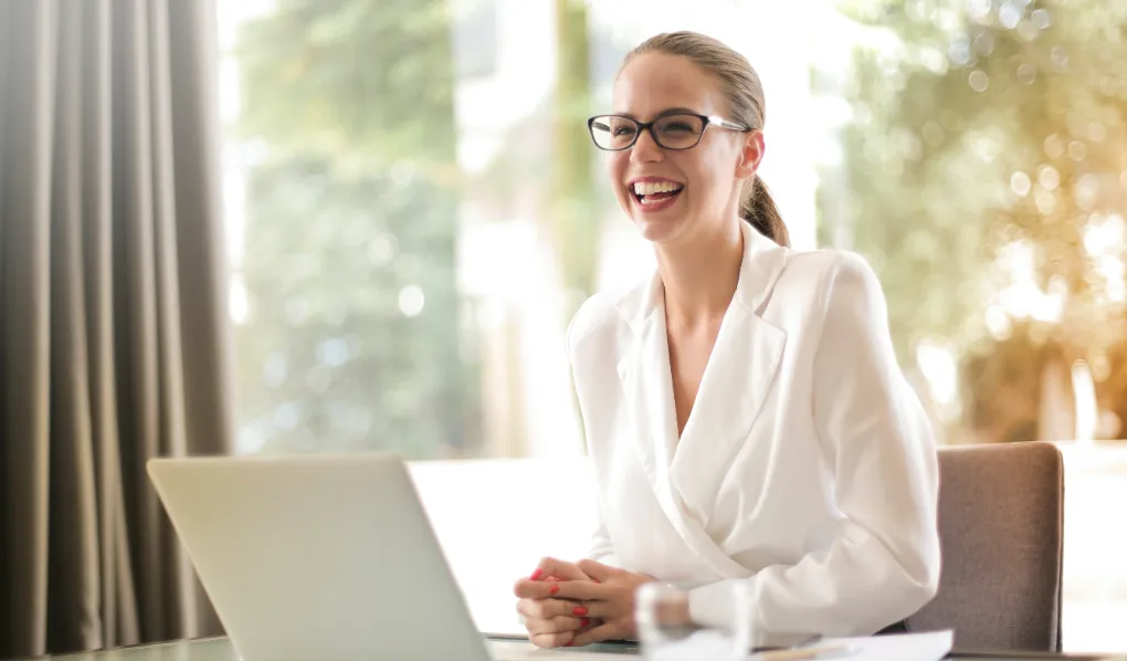 Product Manager sitting at desk laughing