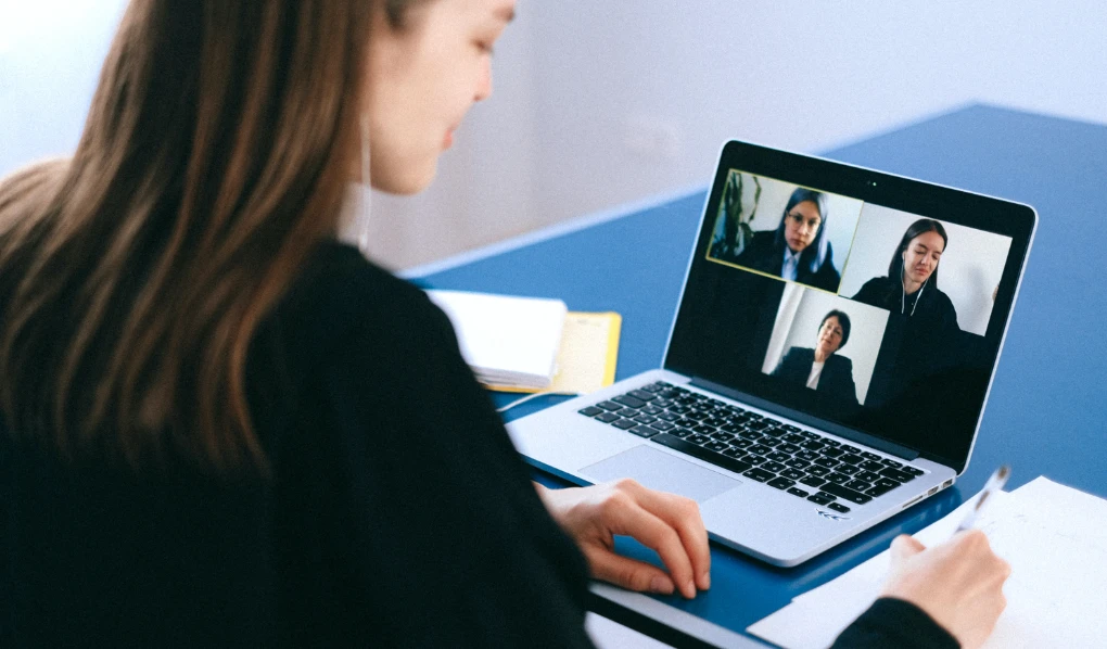 Young female professional on video call with colleagues