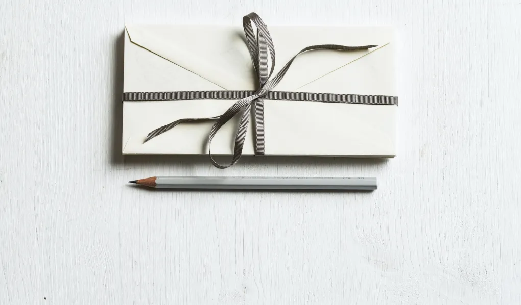 Letter with ribbon and pencil