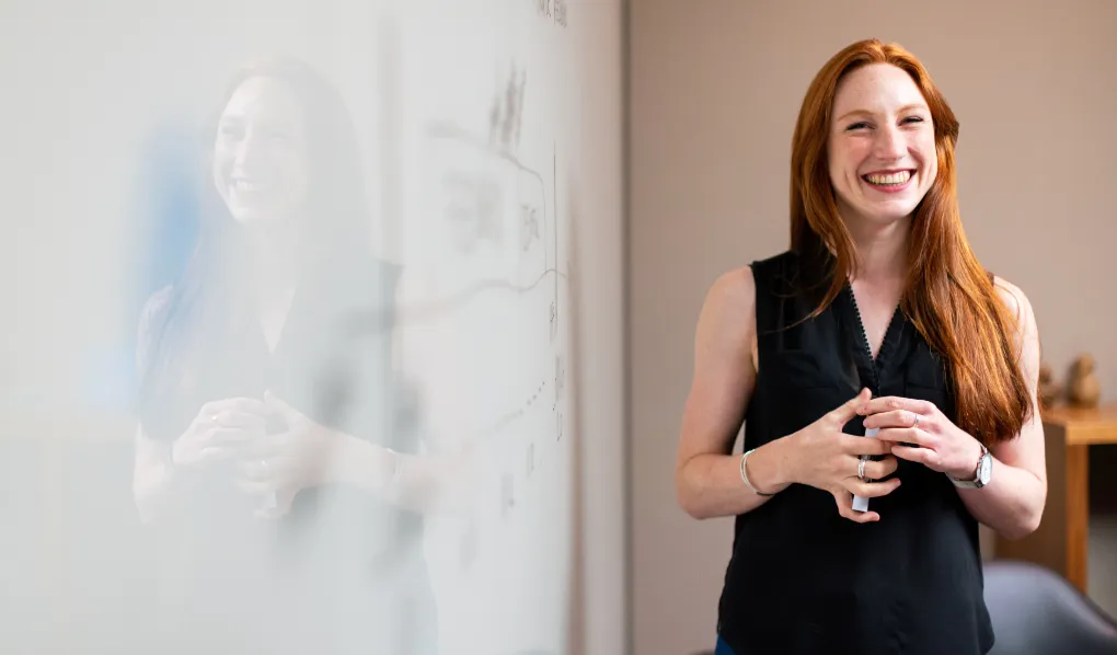 Redhead woman smiling during presentation