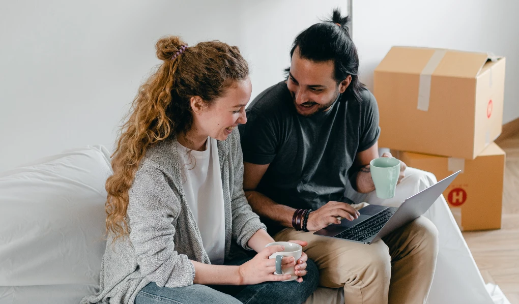 Young smiling couple sitting in their living room