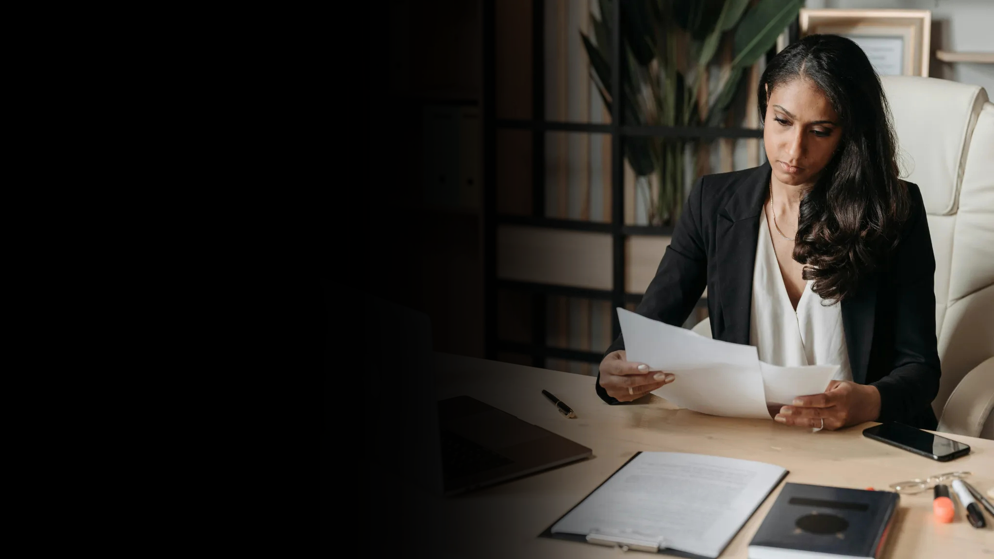 Professional woman reviewing paperwork in her office
